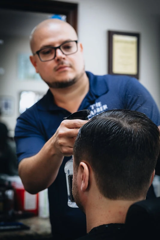 Expert barber at work at The Barber Club, Pompano Beach